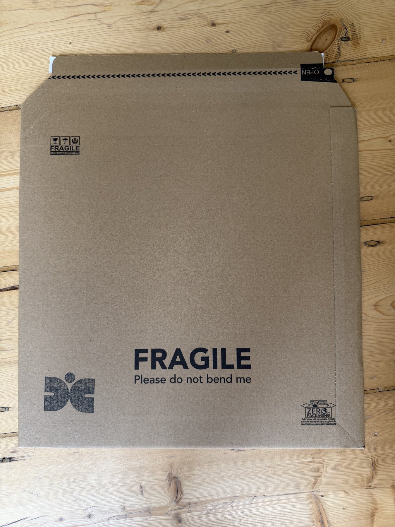 A stamped Deskbound Complex mailer, marked fragile